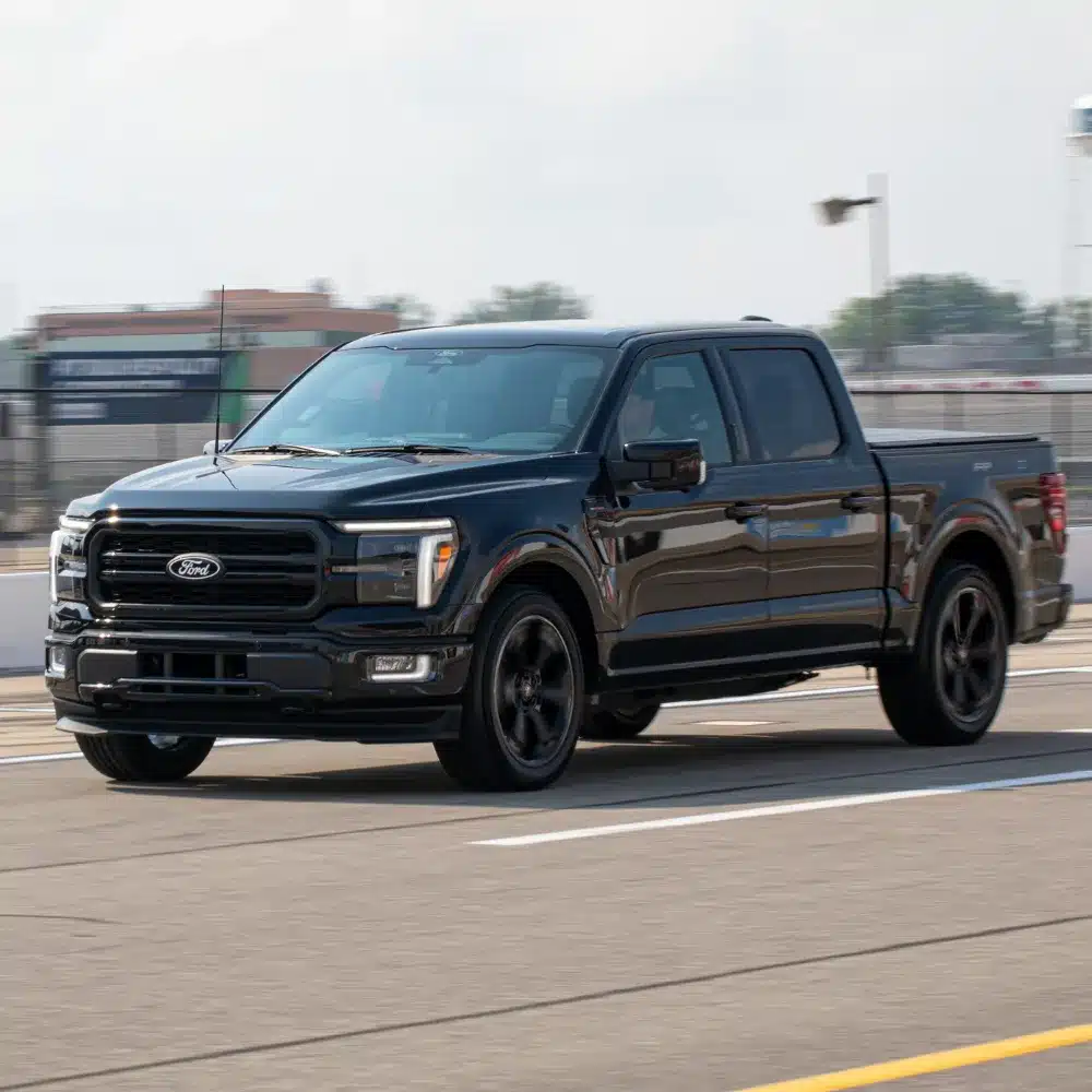 see-which-new-ford-vehicles-available-in-plainville-offer-the-best-value-and-features A lineup of shiny new Ford cars and SUVs parked invitingly at a Plainville dealership.