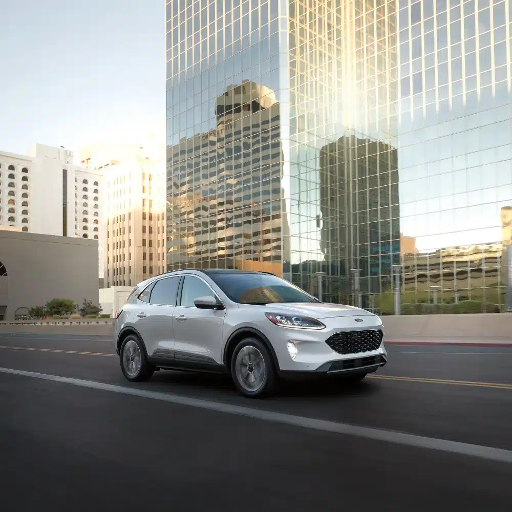 A pristine 2025 Ford Escape hybrid SUV on a dealership lot, ready for test drives.