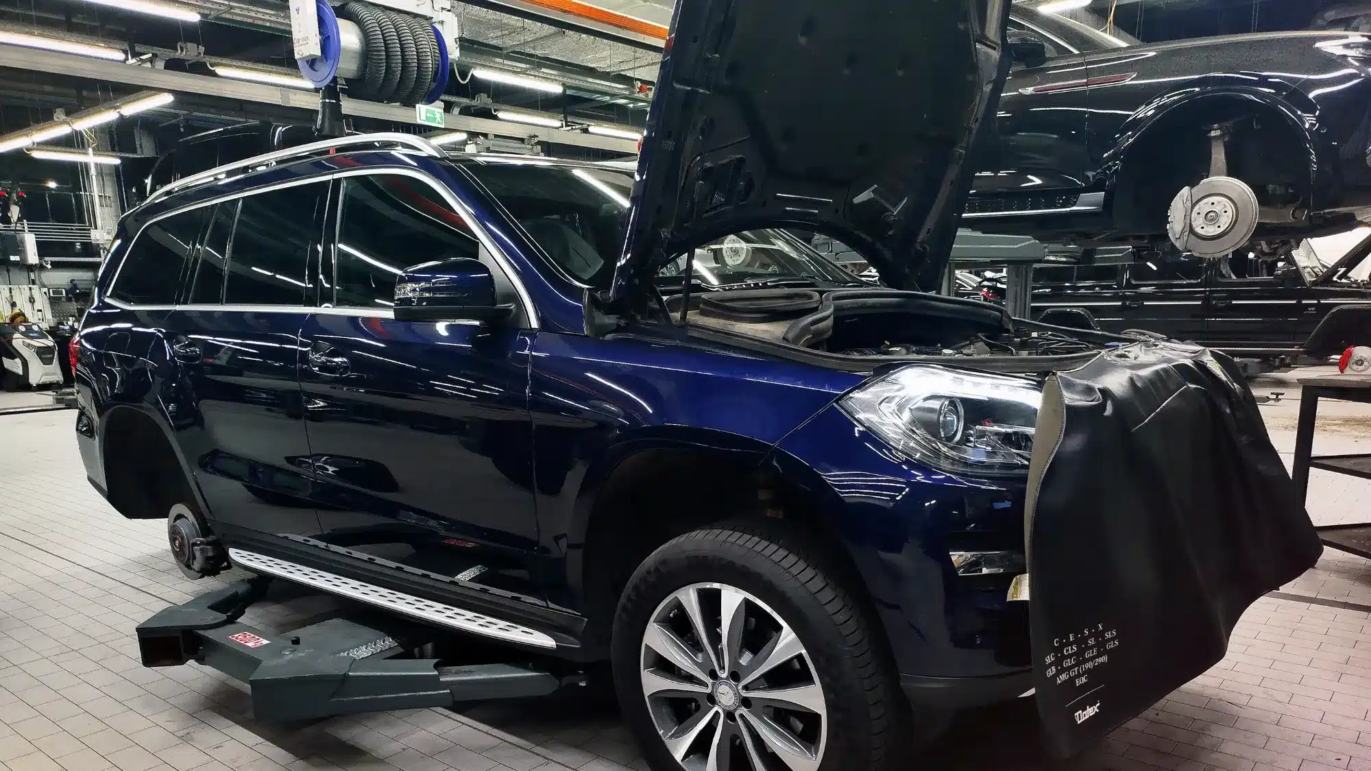 Performance Shop West Palm Beach Luxury SUV undergoing professional performance upgrades and maintenance at an automotive shop in West Palm Beach, with the vehicle raised for specialized service.