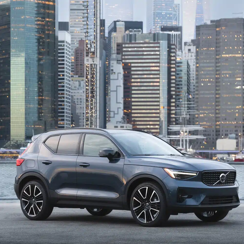 A customer reviews Volvo financing and leasing options with a dealership representative.